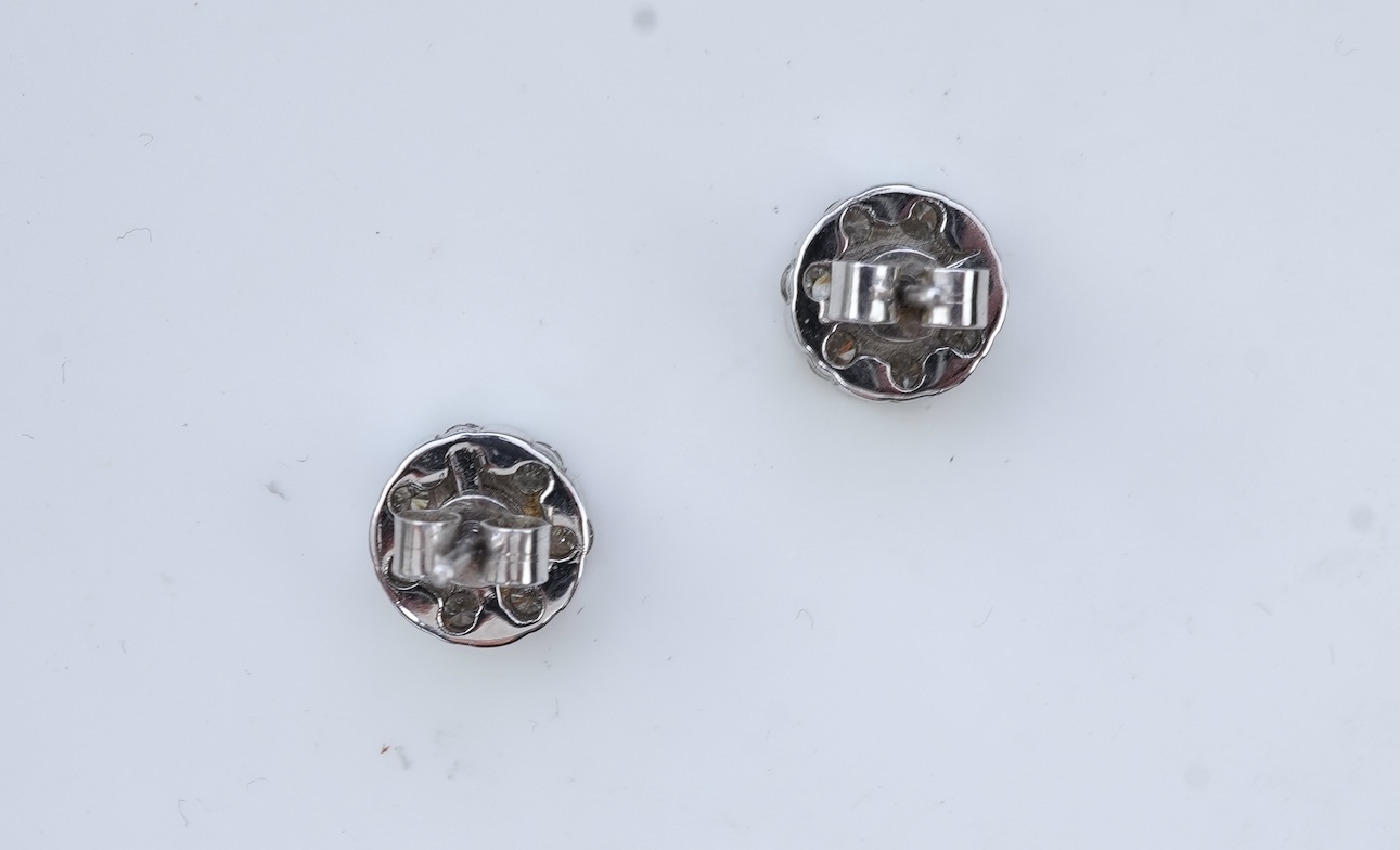 A pair of diamond stud earrings